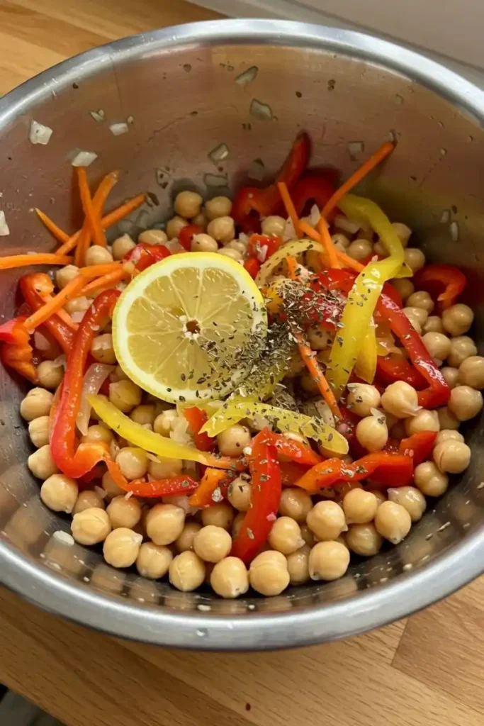 Tossing chickpeas and vegetables for sheet pan dinner
