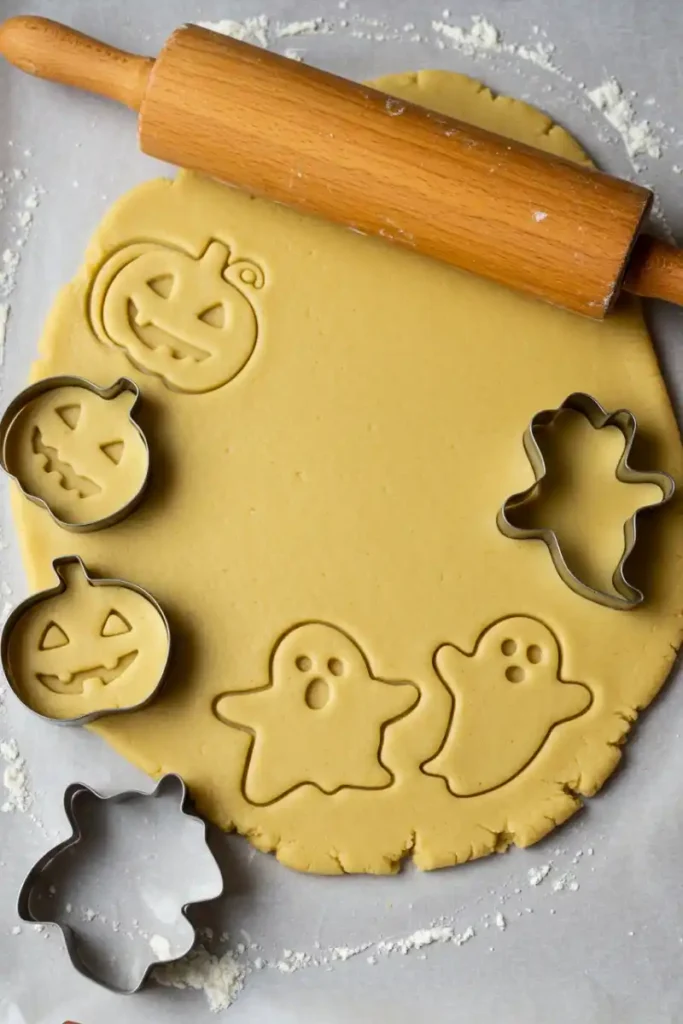 Rolling and cutting gluten free Halloween cookie dough